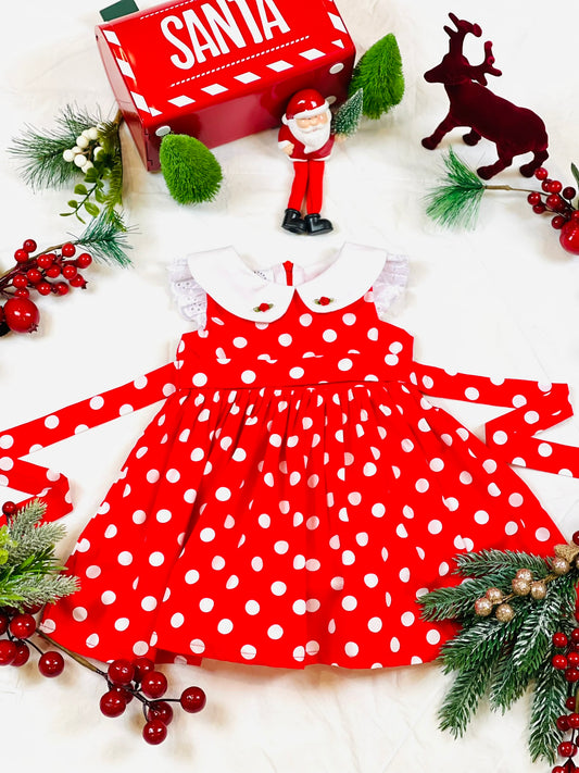 Red and white polka dot dress with white lace gathered frill sleeves and white collar with two red satin rose buds and  rear bow stash.